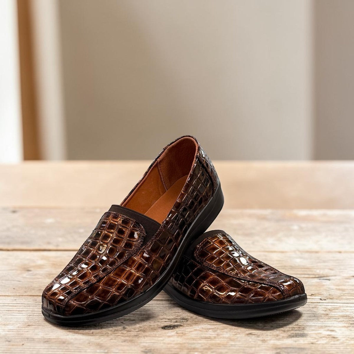 Stefania bronze croc-embossed slip-on shoe with a low wedge sole and elastic side panel.
photo of the front side