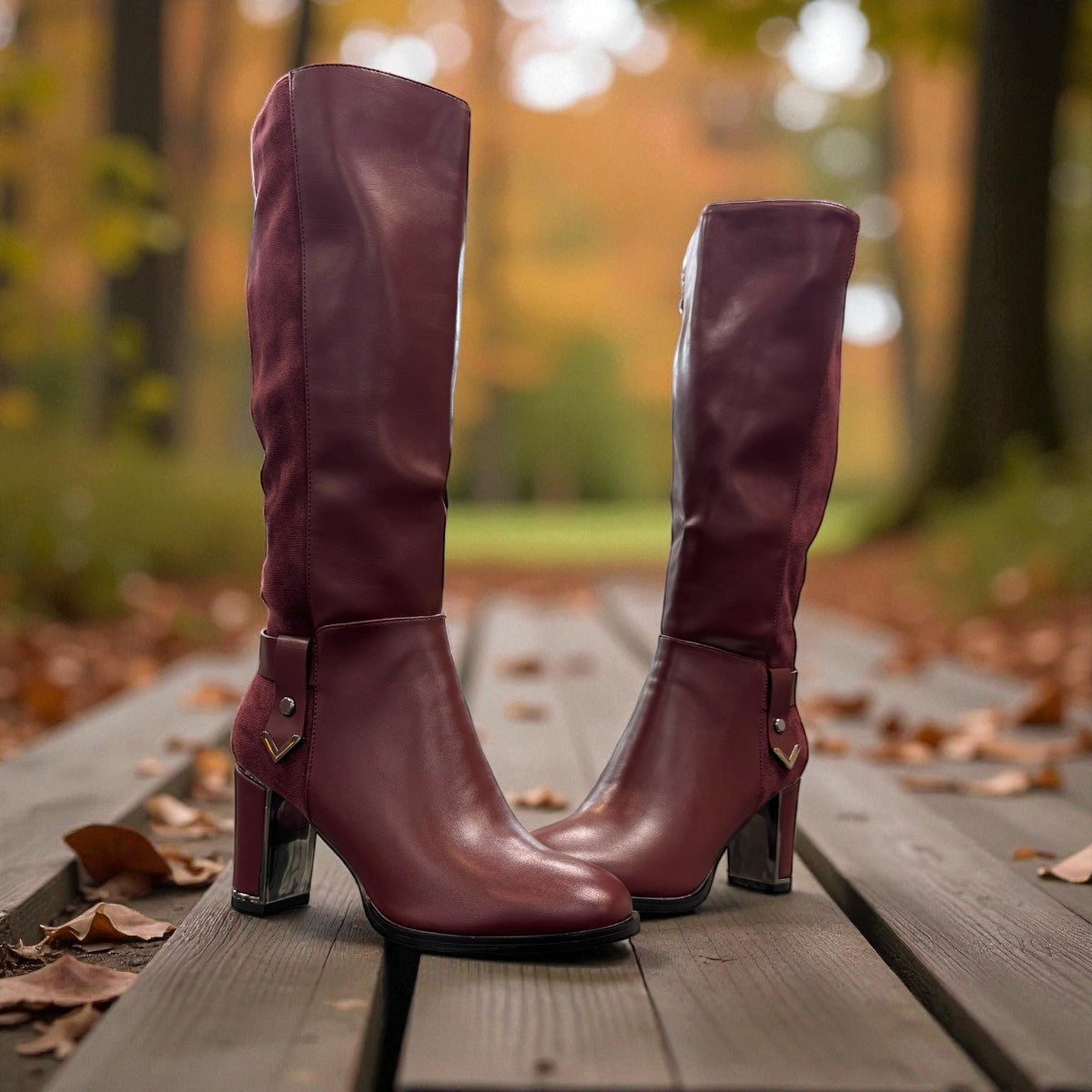 stefania bordo vegan leather knee-high boots with block heel, suede-like panels, and metallic side detail.
photo of the front side