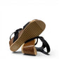 stefania dalia black double-strap wedge sandals with adjustable buckles, cushioned footbed, and cork-style platform sole.
photo of the bottom side
