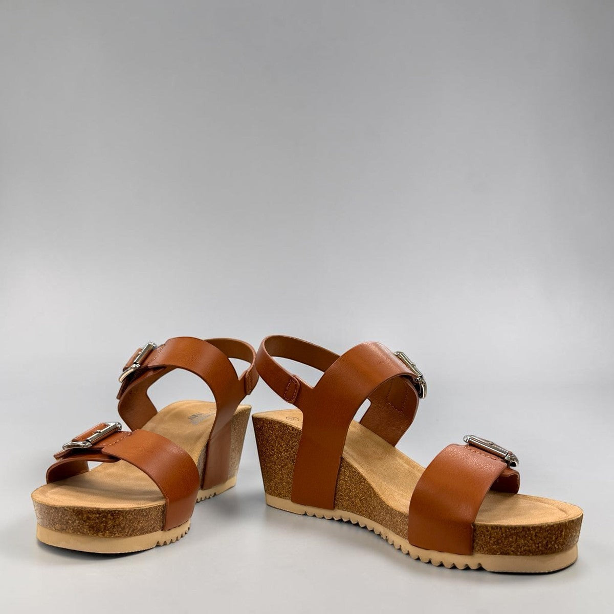 stefania-dalia brown double-strap wedge sandals with adjustable buckles and a cushioned cork-style platform sole.
photo of the front side