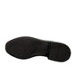 Sun Arad black leather slip-on shoes with woven texture detail and durable rubber outsole. Photo of bottom view.