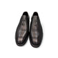 Sun Arad black leather slip-on shoes with woven texture detail and durable rubber outsole. Photo of front view.