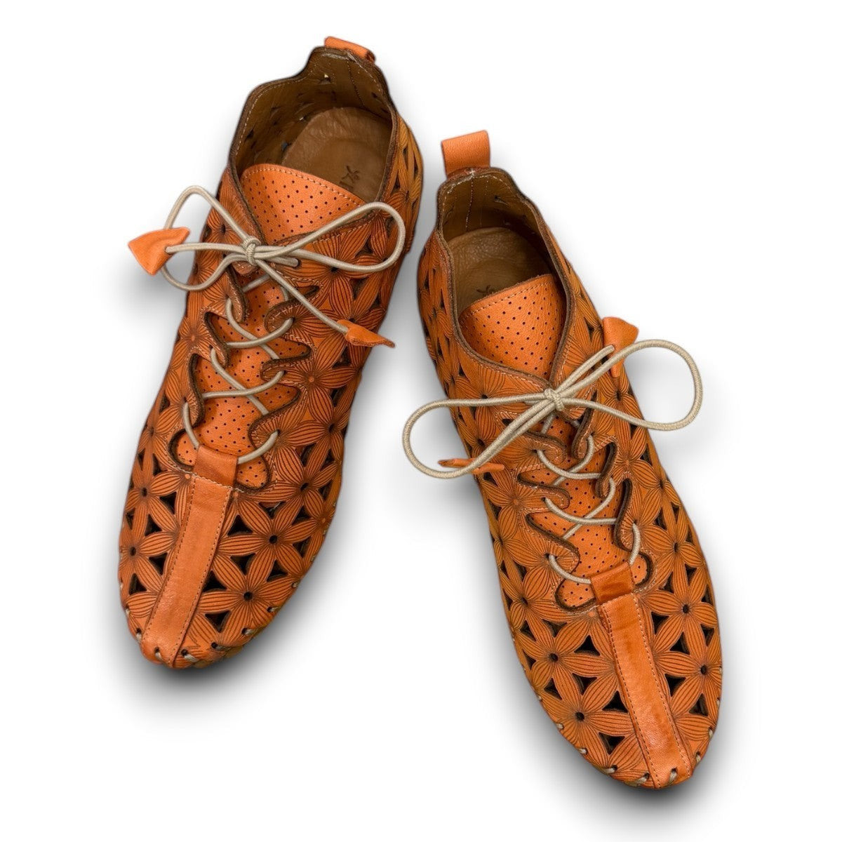 Roamers Venus ankle shoes in sun burn orange leather with decorative floral cutouts and elastic lacing.
photo of the top