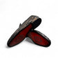 Sun Roniya black leather loafers featuring intricate handmade woven detailing and a rubber outsole. Photo of bottom view.