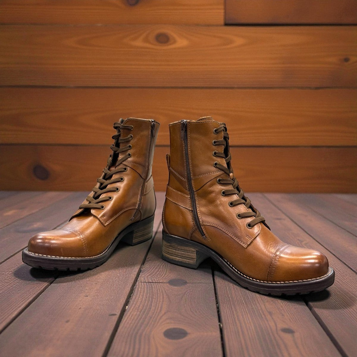 Taos Crave classic camel leather lace-up boot with side buckle and block heel. Photo of side view from the front.
