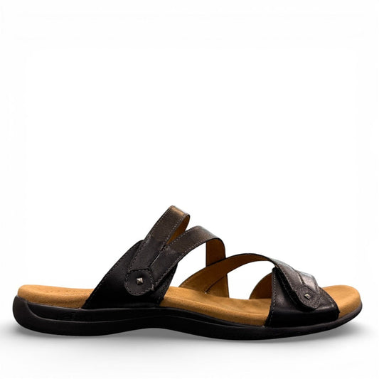 Taos Double U black leather slide sandal with adjustable hook and loop straps and cushioned foot bed. Photo of outside side view.