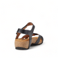 Taos Locke black leather sandal with adjustable hook and loop straps and a supportive cork footbed. Photo of back view.