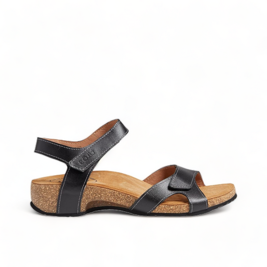 Taos Locke black leather sandal with adjustable hook and loop straps and a supportive cork footbed. Photo of left side view.