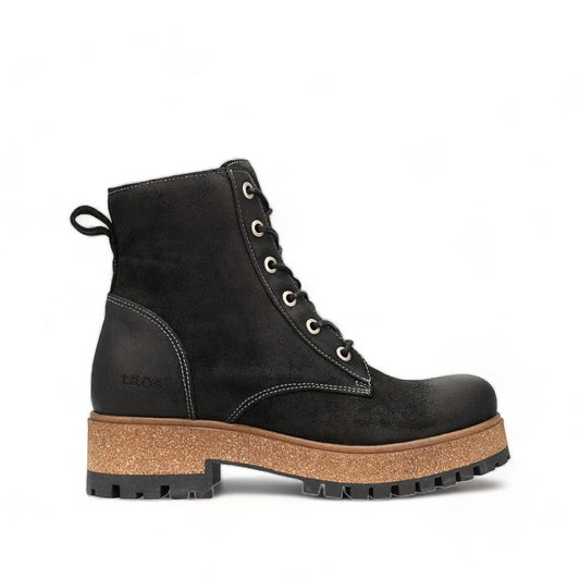 Taos Main Street black rugged leather lace-up platform boot with cork midsole and rubber lug outsole. Photo of left side view.