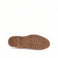 Taos Main Street tan leather lace-up platform boot with a cork midsole and rugged rubber lug outsole. Photo of bottom view.