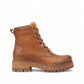 Taos Main Street tan leather lace-up platform boot with a cork midsole and rugged rubber lug outsole. Photo of left side view.