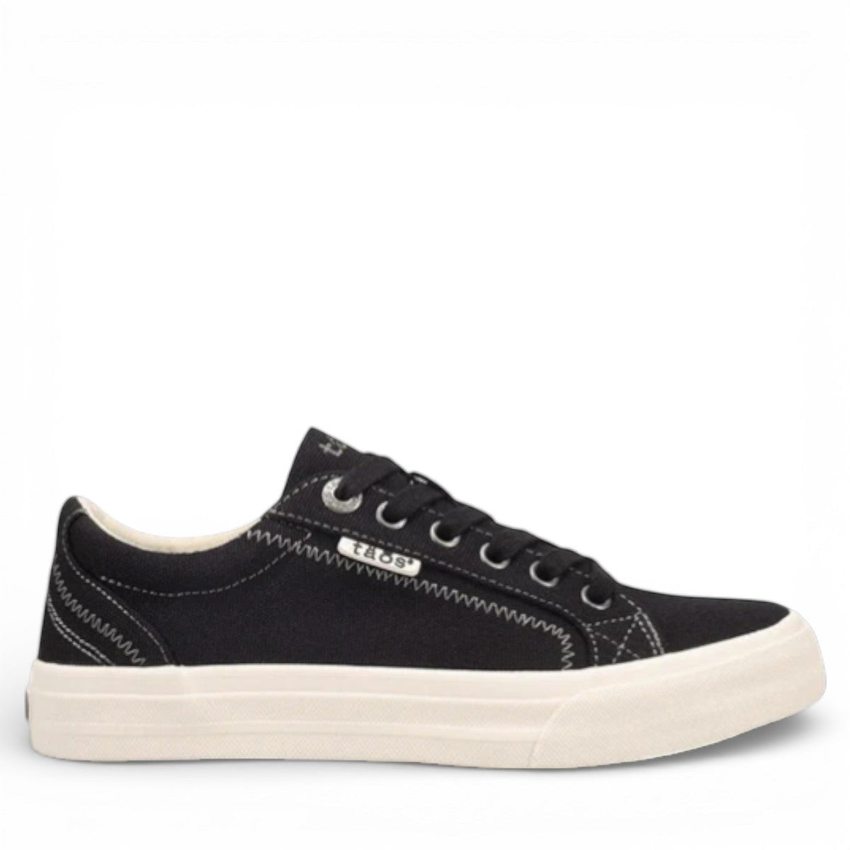 Taos Plim Soul black canvas sneaker with white rubber platform sole and decorative stitching. Photo of outside side view.