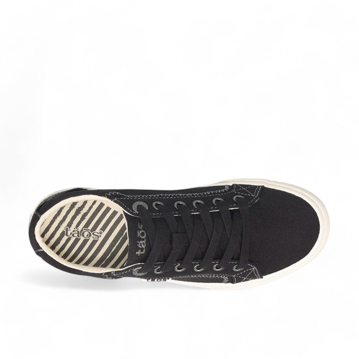 Taos Plim Soul black canvas sneaker with white rubber platform sole and decorative stitching. Photo of upper view.