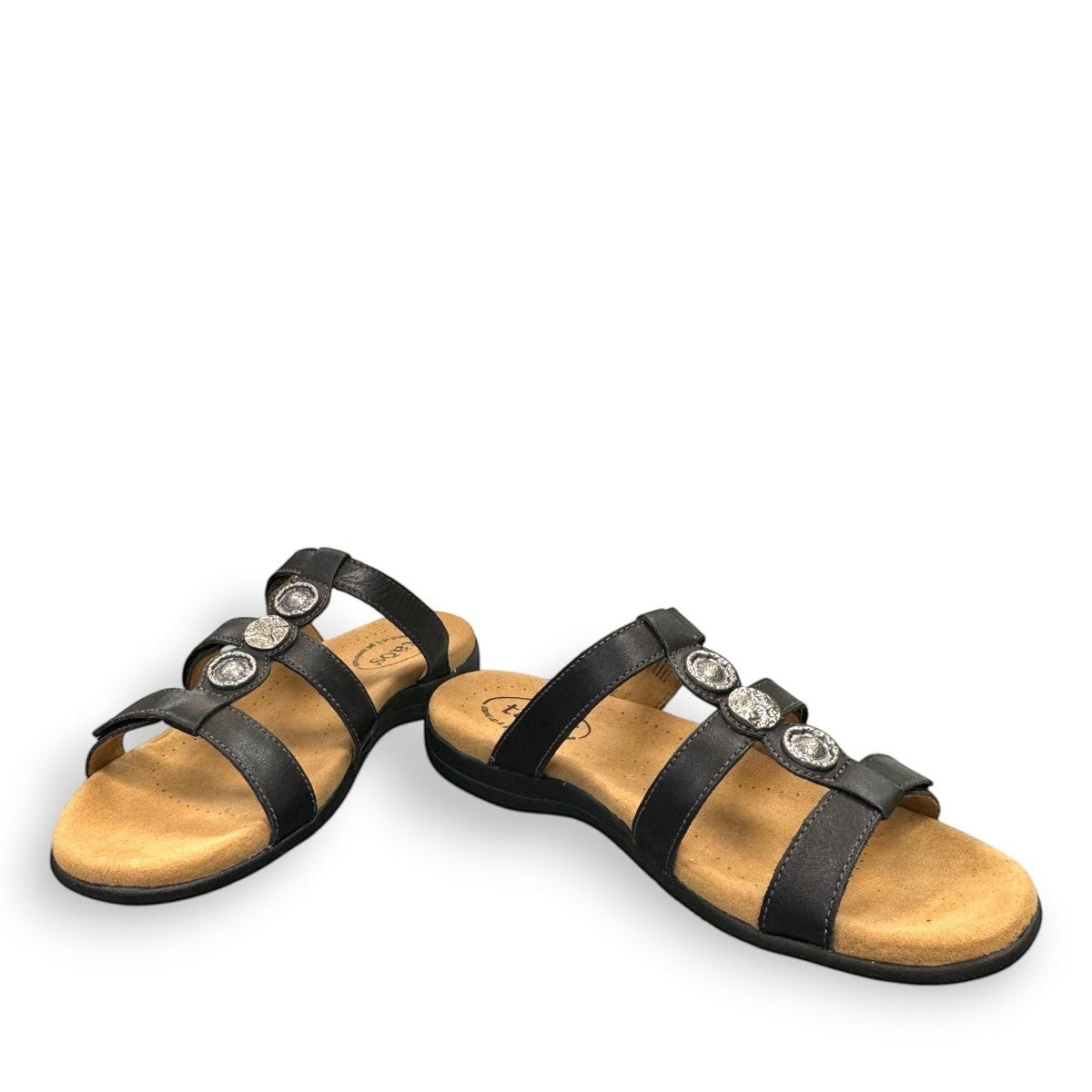 Taos Prize 4 black leather slide sandals with adjustable hook and loop straps and cushioned foot bed. Photo of front view 2.
