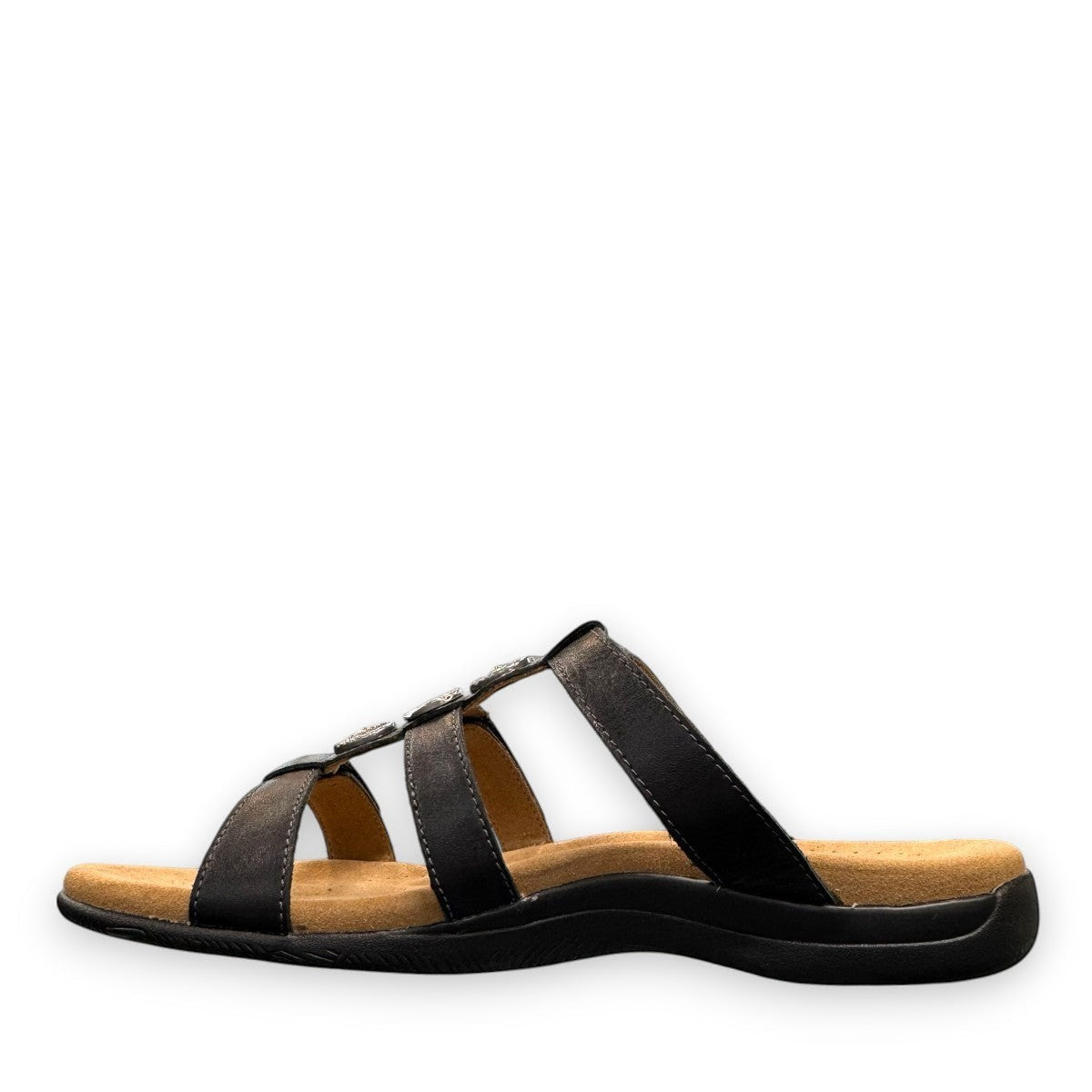 Taos Prize 4 black leather slide sandals with adjustable hook and loop straps and cushioned foot bed. Photo of inside side view.