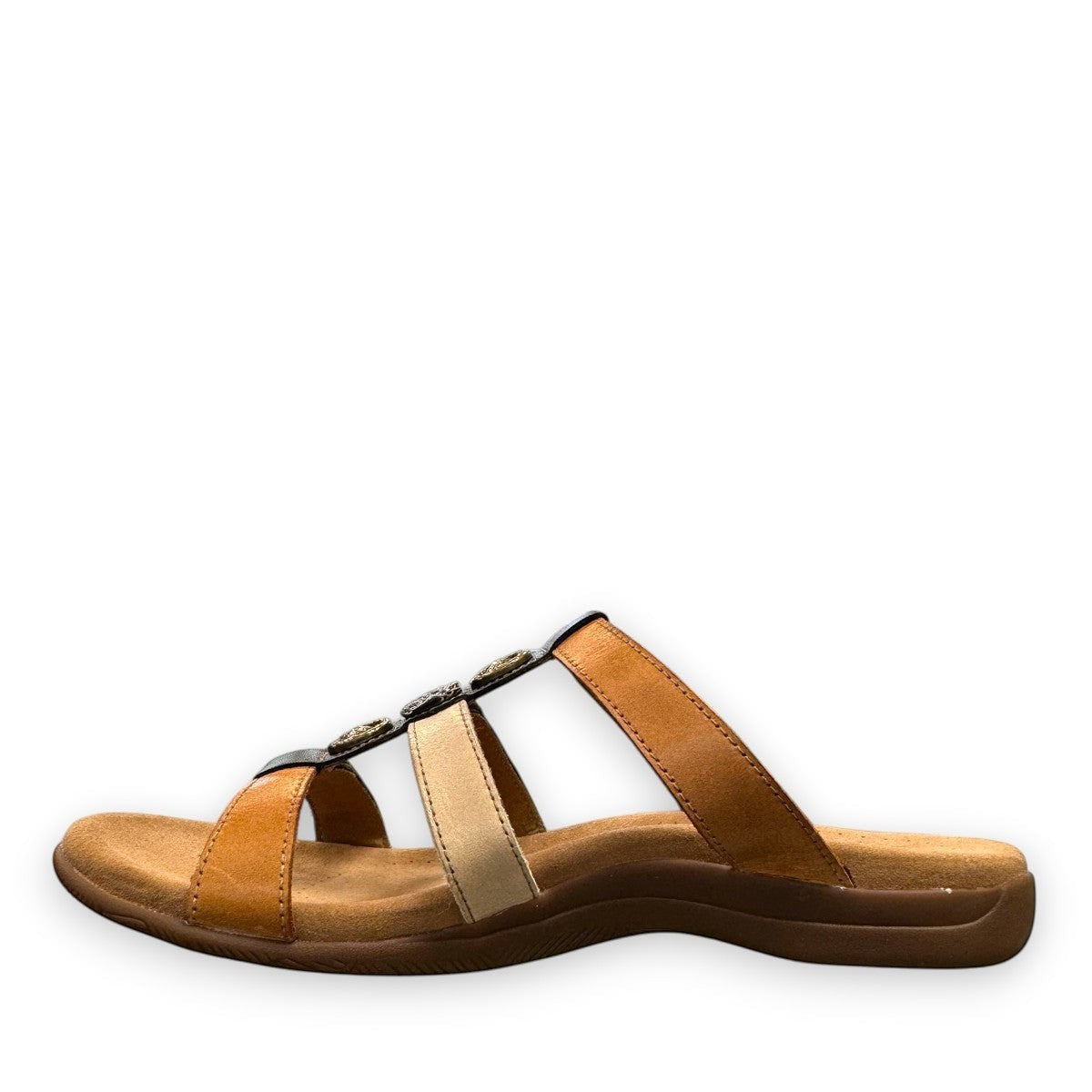 Taos Prize 4 tan multi leather slide sandals with adjustable hook and loop straps and medallion hardware. Photo of inside side view.