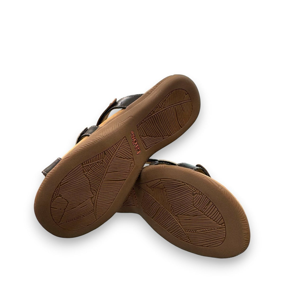 Taos Prize 4 tan multi leather slide sandals with adjustable hook and loop straps and medallion hardware. Photo of bottom view.