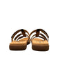 Taos Prize 4 tan multi leather slide sandals with adjustable hook and loop straps and medallion hardware. Photo of back view.