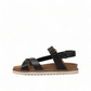 Taos Sideways black leather adjustable sandal with cork midsole and off-white EVA outsole. Photo of left side view.