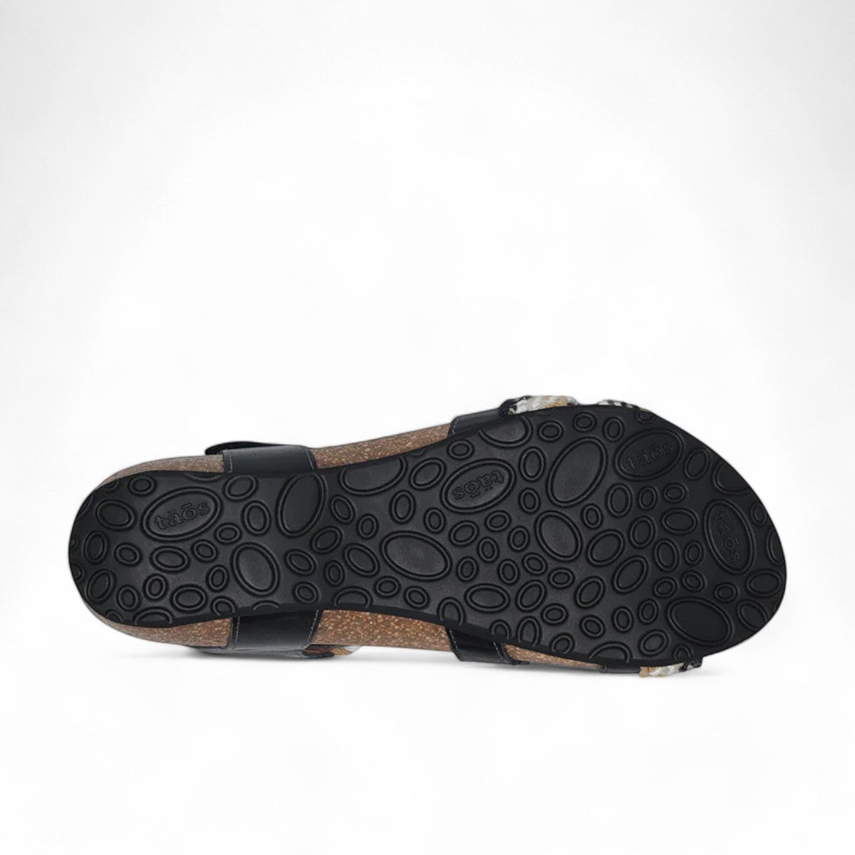Taos Trulie L.E. black multi woven adjustable sandal with cork foot bed and arch support. Photo of bottom view.