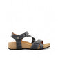 Taos Universe navy leather sandals with Z-strap design, cork foot bed, and medallion embellishments. Photo of side view.