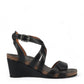 Taos Xcellent black leather wedge sandals with crisscross straps and cork foot bed. Photo of outside side view.