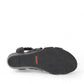 Taos Xcellent black leather wedge sandals with crisscross straps and cork foot bed. Photo of bottom view.