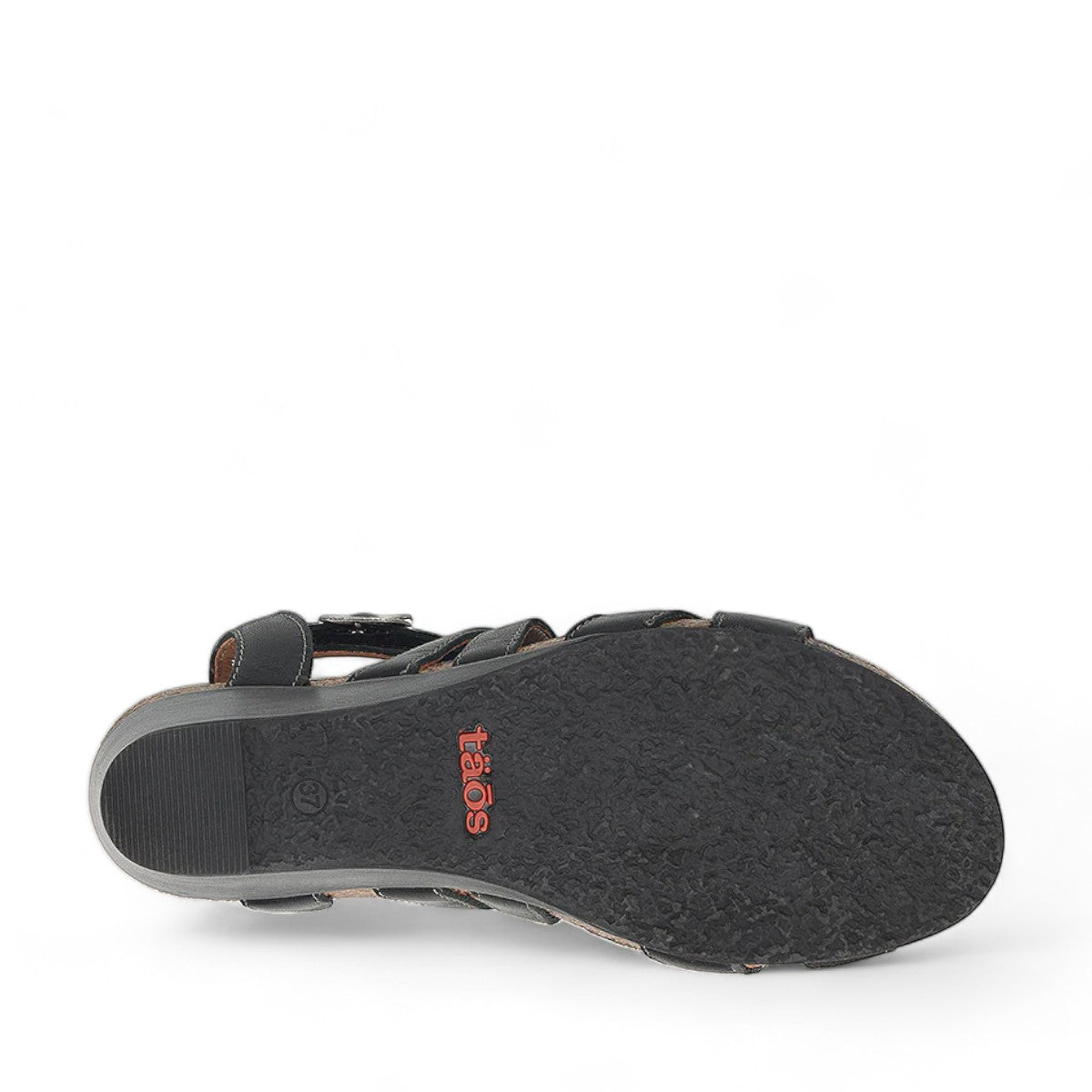 Taos Xcellent black leather wedge sandals with crisscross straps and cork foot bed. Photo of bottom view.