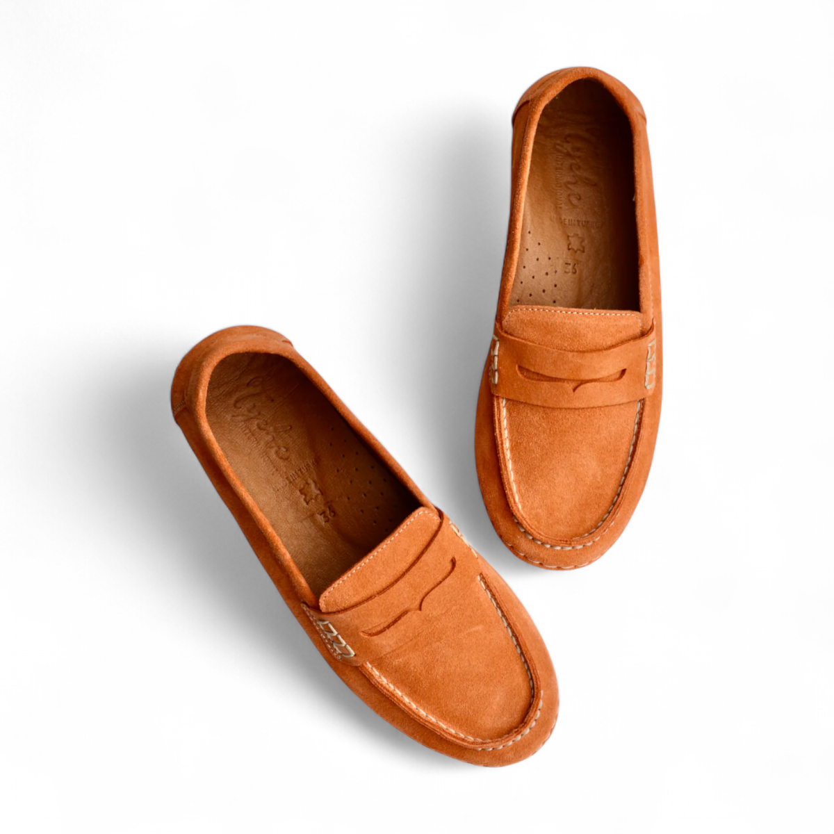 Tyche Mavis orange suede loafers with slip-on design, leather lining, and contrast stitching.