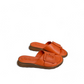 Tyche Monroe orange leather slide sandals with adjustable buckle and comfortable cushioned insole. Photo of side views.