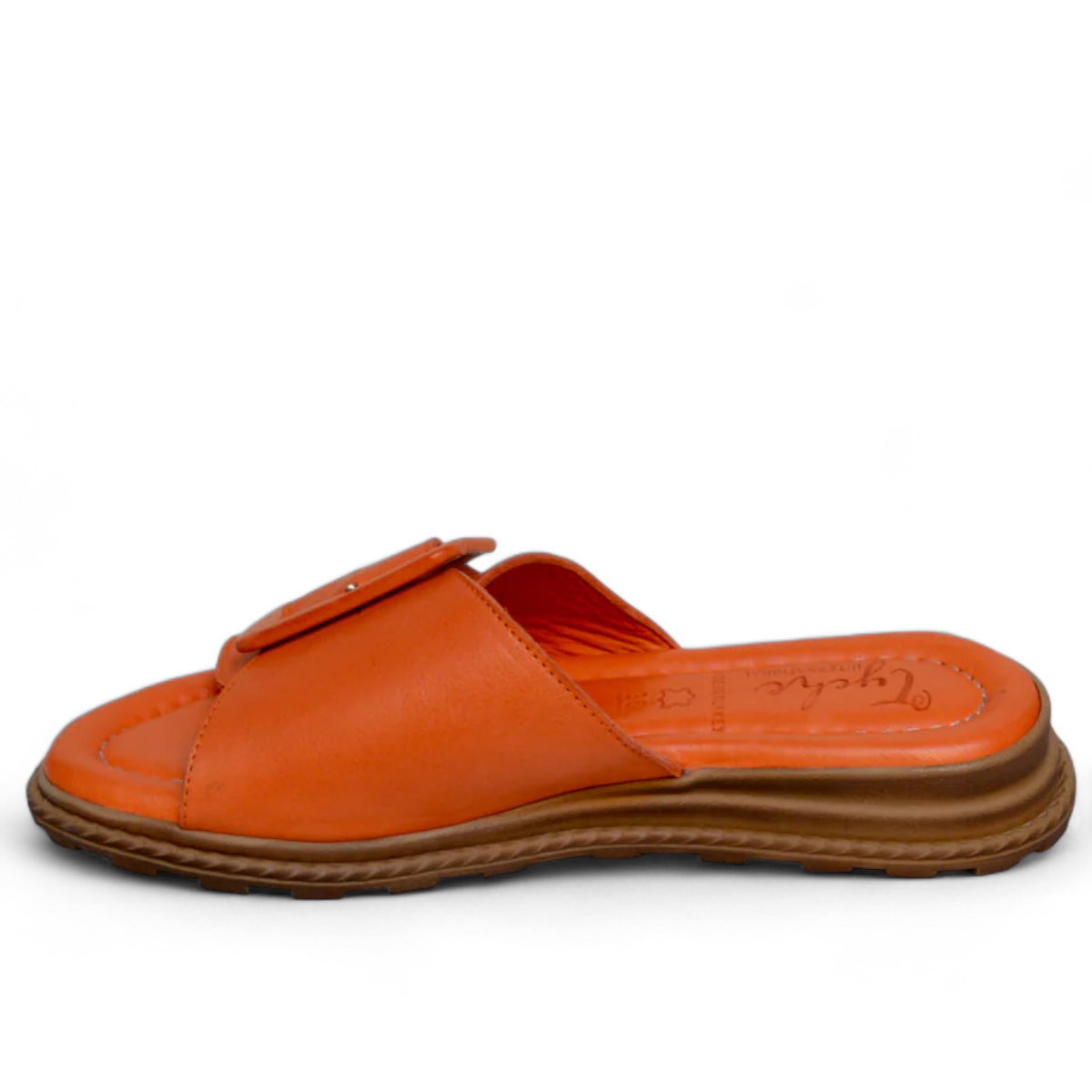 Tyche Monroe orange leather slide sandals with adjustable buckle and comfortable cushioned insole. Photo of left side view.