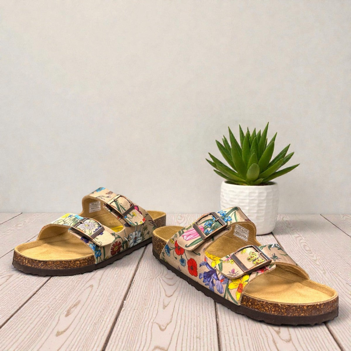 Viking Chatham toe-loop sandal with a beige floral wild garden print, cork midsole, and adjustable buckles.
photo of the front side