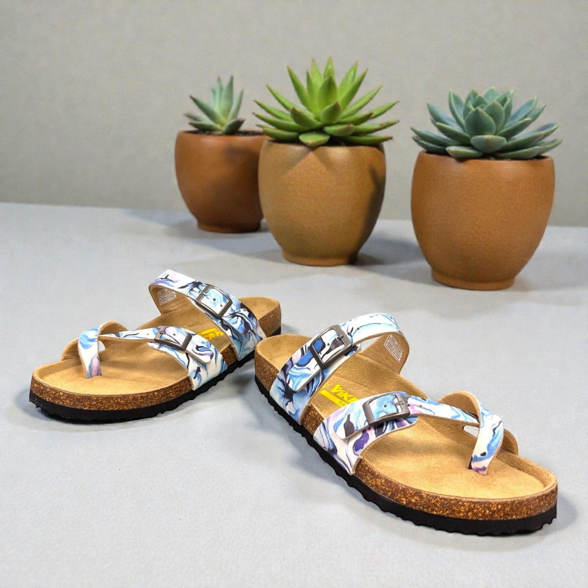 Viking Chatham toe-loop sandal with a beige floral wild garden print, cork midsole, and adjustable buckles.
photo of the front side