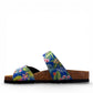 Viking Verlo slide sandals featuring a vibrant blue tropical floral print, two adjustable buckles, and a cork sole.
photo of the left side