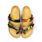 Vikings Tofino toe-loop sandals in black hibiscus floral print with adjustable buckles and cork midsole.
photo of the top side