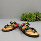 Vikings Tofino toe-loop sandals in black hibiscus floral print with adjustable buckles and cork midsole.
photo of the front side