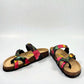 Vikings Tofino toe-loop sandals in black hibiscus floral print with adjustable buckles and cork midsole.
photo of the front side