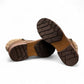 Wanderlust ankle boot in brown faux leather with a chunky knit cuff, side zipper, and lugged sole.