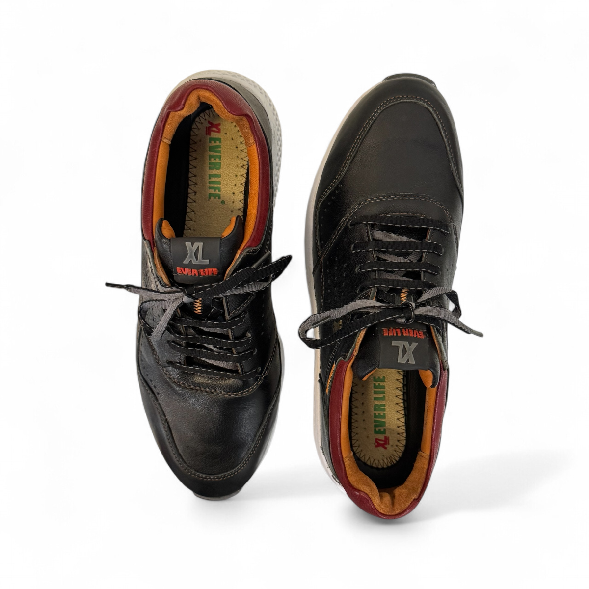 XL EVER LIFE HANNA black leather sneaker with a white textured sole and maroon heel detail. Photo of upper view.