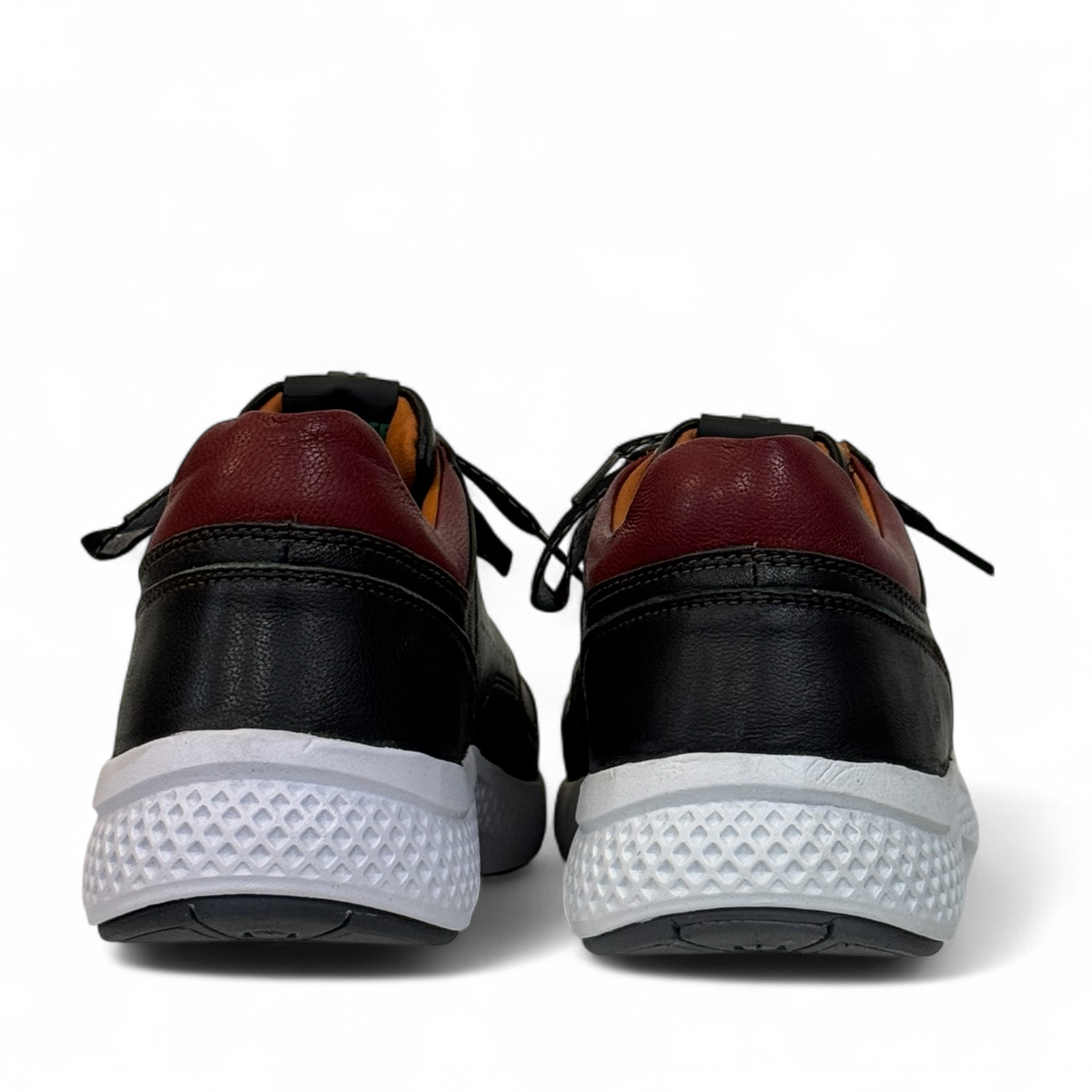 XL EVER LIFE HANNA black leather sneaker with a white textured sole and maroon heel detail. Photo of back view.