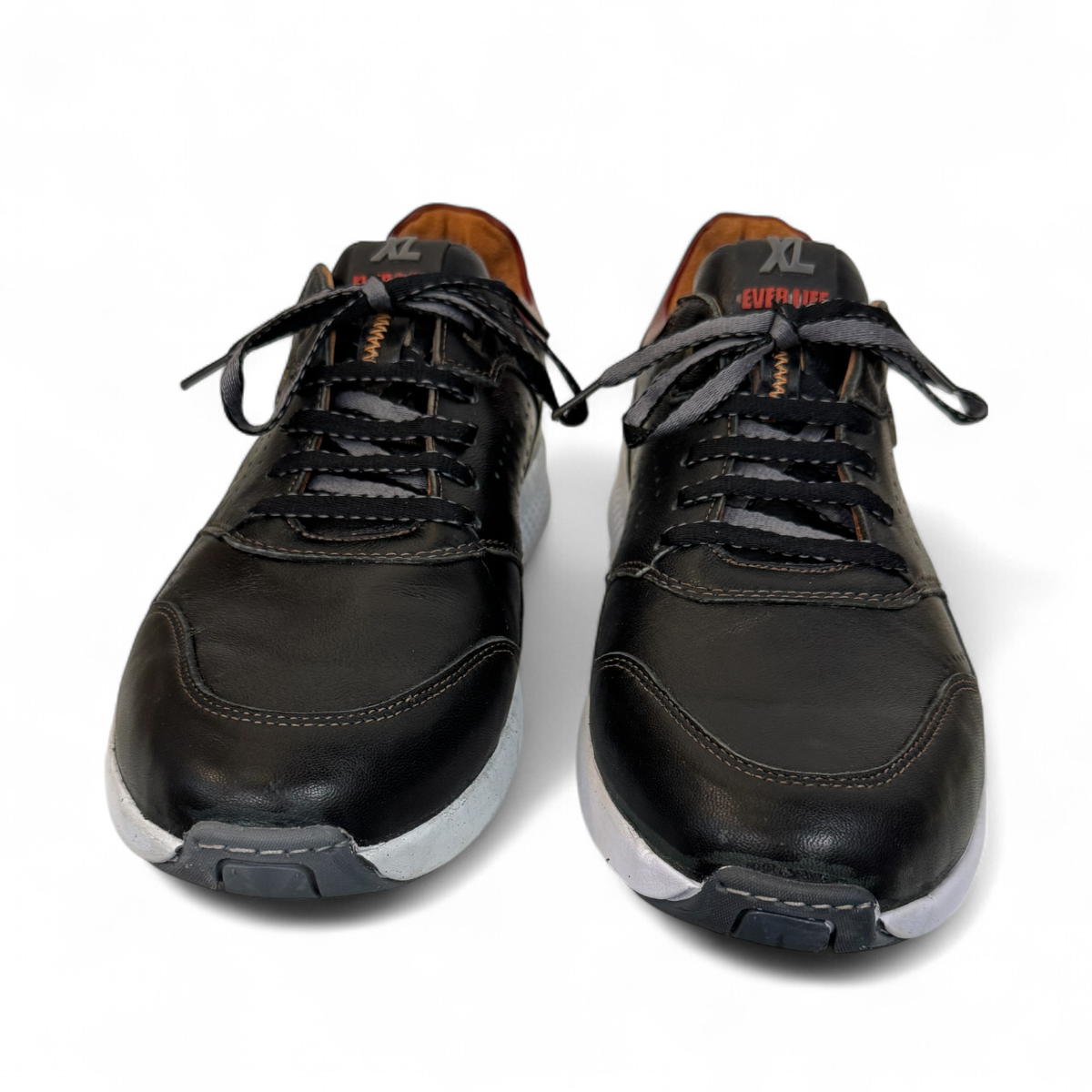 XL EVER LIFE HANNA black leather sneaker with a white textured sole and maroon heel detail. Photo of front view.